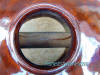 soundhole showing mahogany wood through to anchor